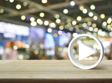 Tahta masadaki 3D simgesini bulanık ışık ve alışveriş merkezinin gölgesi üzerine oynat, iş müziği online konsepti