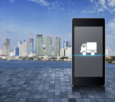 Kamyon teslimatı düz simgesi modern akıllı cep telefonu ekranında taş döşeme zemininde şehir kulesi, nehir ve mavi gökyüzü üzerinde iş kamyonu taşımacılığı çevrimiçi servis konsepti