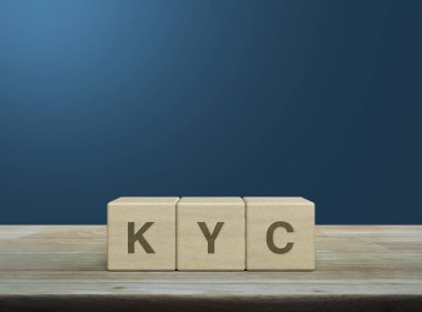 KYC kısaltması ahşap küpler üzerinde açık mavi duvar üzerinde ahşap masa, müşteri konseptini biliyorum