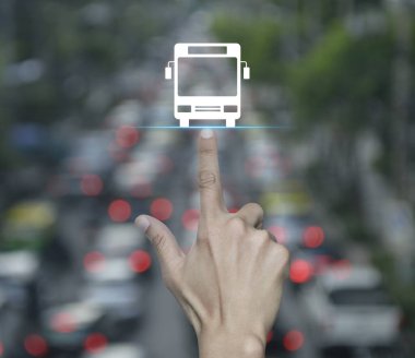 Hand pressing bus flat icon over blur of rush hour with cars and road in city, Business transportation service concept