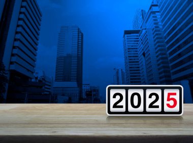 Retro flip clock with 2025 text on wooden table over modern city tower and skyscraper, Happy new year 2025 cover concept clipart