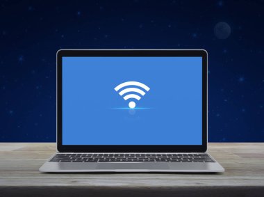 Modern dizüstü bilgisayardaki Wi-Fi düz ikonu tahta masadaki ekranı fantezi gece gökyüzü ve ay, kablosuz teknoloji konsepti