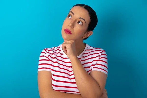 Portrait Thoughtful Woman Wearing Striped Shirt Keeps Hand Chin Looks — Stock Photo, Image