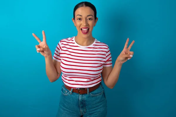 Woman Wearing Striped Shirt Optimistic Smile Showing Peace Victory Gesture — Stock Photo, Image