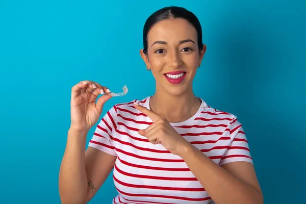 Woman Wearing Striped Shirt Holding Invisible Aligner Pointing Dental Healthcare — Stock Photo, Image