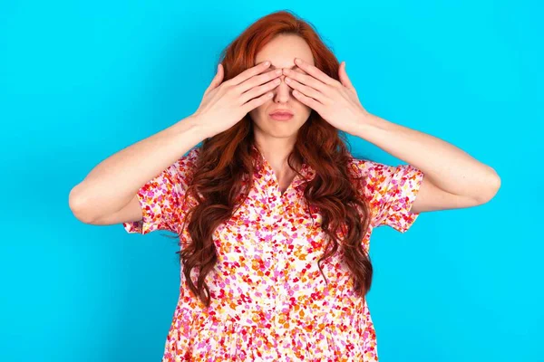 Redhead Woman Wearing Floral Dress Blue Background Covering Eyes Both — Stock Photo, Image