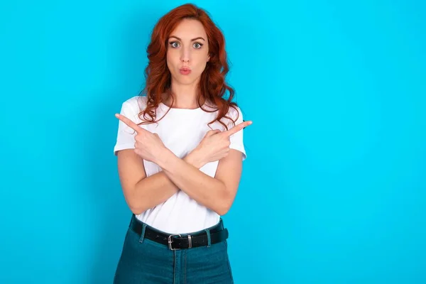 Confused Redhead Woman Wearing White Shirt Blue Background Chooses Two — Stock Photo, Image
