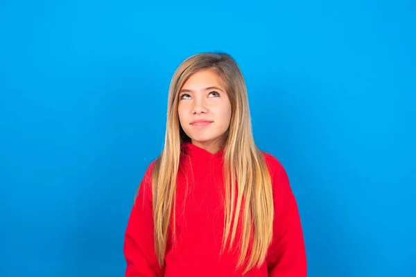 Blonde Caucasian Teen Girl Wearing Red Sweatshirt Blue Background Has — Stock Photo, Image
