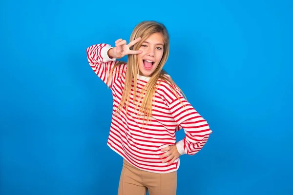 Adolescente Chica Con Camisa Rayas Sobre Fondo Azul Haciendo Signo —  Fotos de Stock