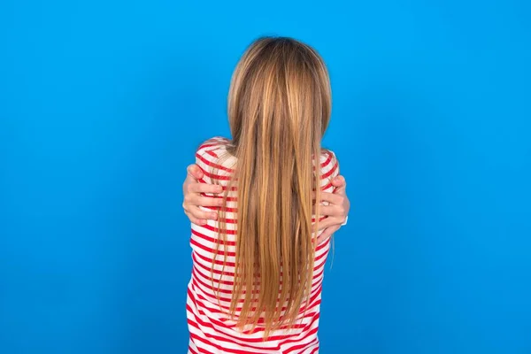 Teenie Mädchen Gestreiftem Hemd Vor Blauem Hintergrund Umarmt Sich Glücklich — Stockfoto