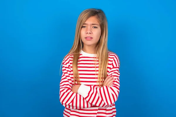 Dospívající Dívka Pruhované Košili Přes Modré Pozadí Mračí Tvář Nelibosti — Stock fotografie