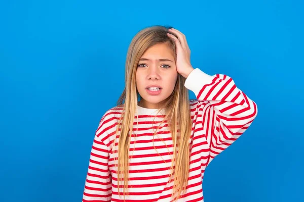 Portrait Confused Teen Girl Wearing Striped Shirt Blue Background Holding — Stock Photo, Image