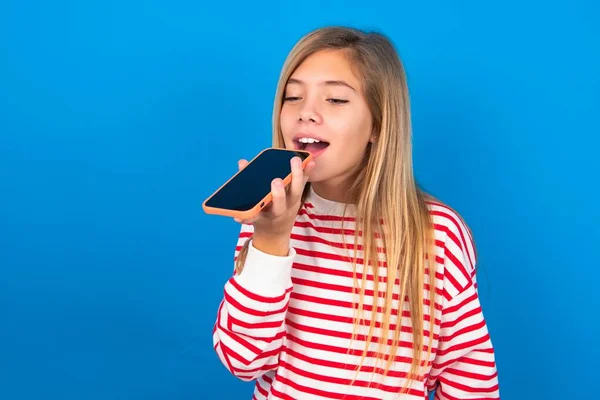 Smiling Teen Girl Wearing Striped Shirt Blue Background Sending Voice — Stock Photo, Image