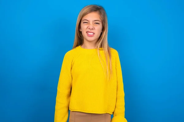Portrait Dissatisfied Caucasian Teen Girl Wearing Yellow Sweater Blue Studio — Stock Photo, Image