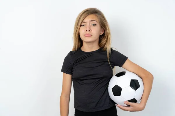 Displeased Teen Girl Wearing Sportswear Holding Football Ball White Wall — Stock Photo, Image