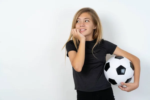 Terrified Teen Girl Wearing Sportswear Holding Football Ball White Wall — Stock Photo, Image