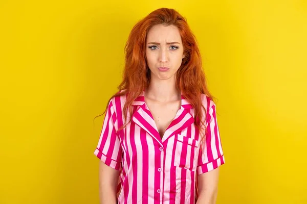 Displeased Upset Red Haired Woman Wearing Pink Pyjama Yellow Studio — Stock Photo, Image