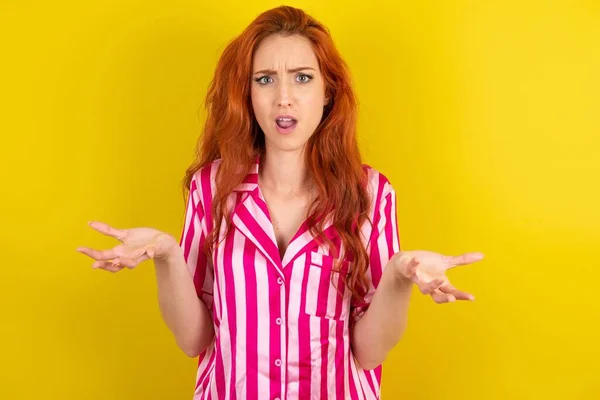 Frustrated Red Haired Woman Wearing Pink Pyjama Yellow Studio Background — Stock Photo, Image