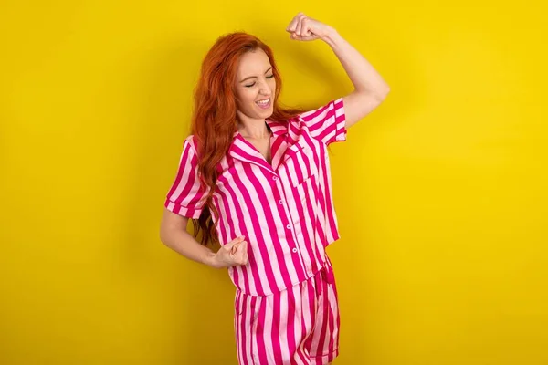 Stüdyonun Arka Planında Pembe Pijama Giyen Heyecanlı Kızıl Saçlı Bir — Stok fotoğraf