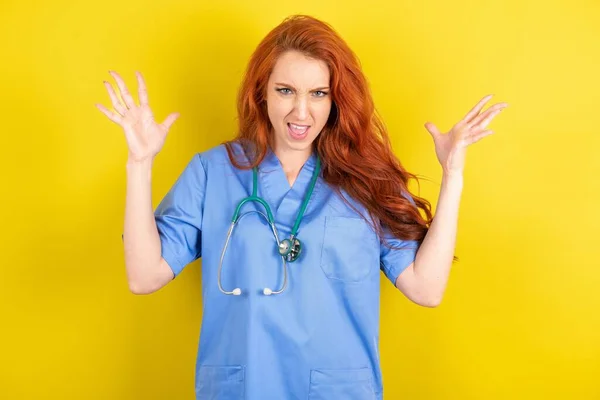 Crazy Outraged Red Haired Doctor Woman Yellow Studio Background Screams — Stock Photo, Image