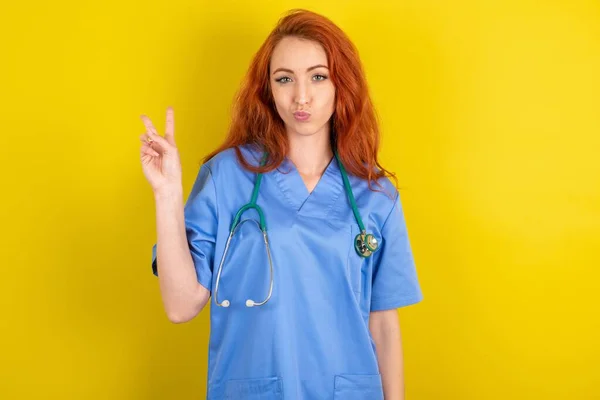 Young Red Haired Doctor Woman Yellow Studio Background Makes Peace — Stock Photo, Image
