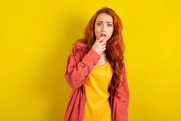 Nervous Puzzled Beautiful Red Haired Woman Standing Yellow Studio Background — Stock Photo, Image
