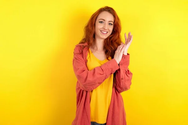 Beautiful Red Haired Woman Standing Yellow Studio Background Clapping Applauding — Stock Photo, Image