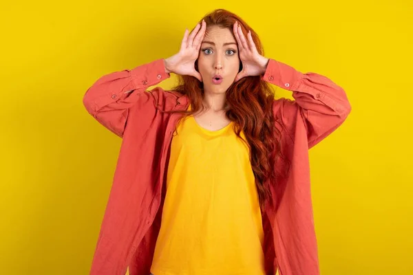 Beautiful Red Haired Woman Standing Yellow Studio Background Scared Expression — Stock Photo, Image