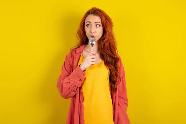 Very Hungry Red Haired Woman Standing Yellow Studio Background Holding — Stock Photo, Image