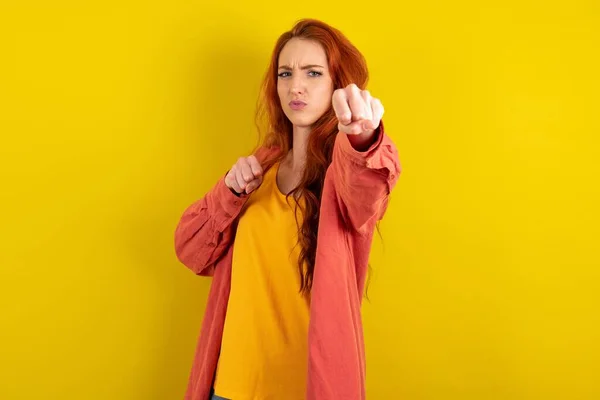 Beautiful Red Haired Woman Standing Yellow Studio Background Punching Fist — Stock Photo, Image