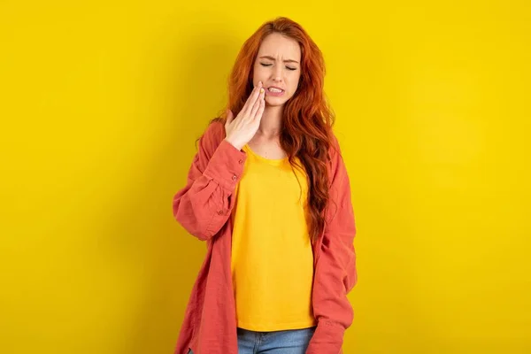 Beautiful Red Haired Woman Standing Yellow Studio Background Touching Mouth — Stock Photo, Image