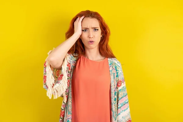 Embarrassed Red Haired Woman Standing Yellow Studio Background Shocked Expression — Stock Photo, Image
