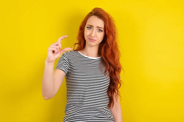 Displeased Red Haired Woman Wearing Striped Shirt Yellow Studio Background — Stock Photo, Image