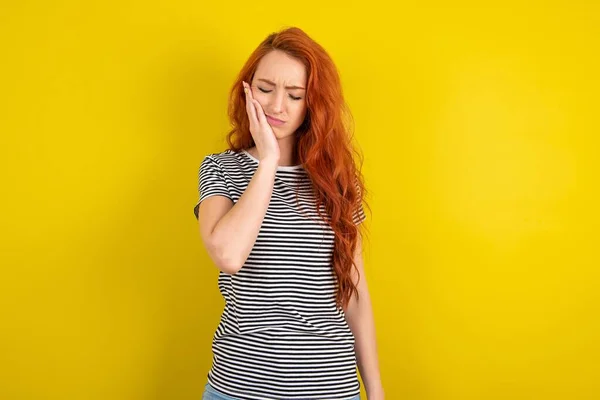 Red Haired Woman Wearing Striped Shirt Yellow Studio Background Toothache — Stock Photo, Image