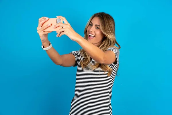 Young Beautiful Woman Wearing Striped Shirt Blue Background Taking Selfie — Stock Photo, Image