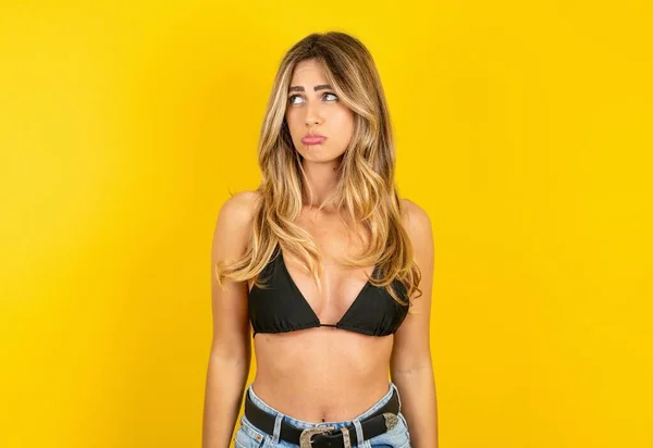 Dissatisfied Young Blonde Woman Wearing Bikini Yellow Background Purses Lips — Stock Photo, Image