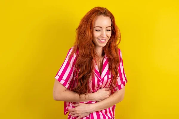 Sarı Arka Planda Pembe Pijama Giyen Genç Kızıl Saçlı Bir — Stok fotoğraf