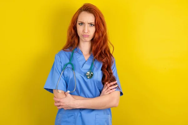 Gloomy Dissatisfied Young Red Haired Doctor Woman Looks Miserable Expression — Stock Photo, Image