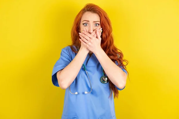 驚いた若い赤毛の医師の女性は 驚くべきことを恐れて 両手を口に覆います — ストック写真