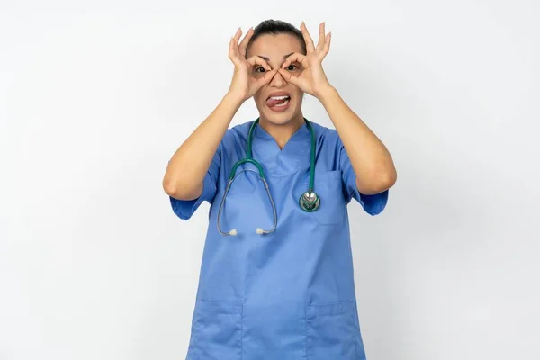 Arab Doctor Woman Wearing Blue Uniform Doing Gesture Binoculars Sticking — Stock Photo, Image