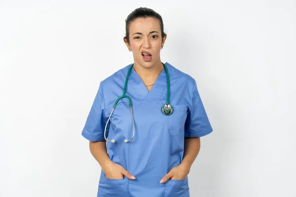 Portrait Dissatisfied Arab Woman Doctor Uniform Stethoscope Smirks Face Purses — Stock Photo, Image