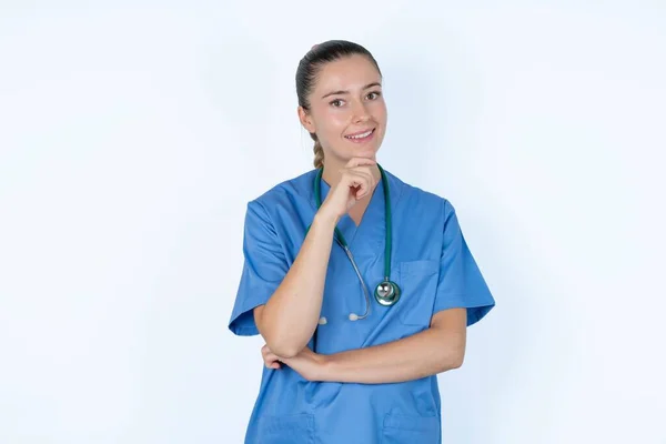 Caucasian Female Doctor Laughs Happily Keeps Hand Chin Expresses Positive — Stock Photo, Image