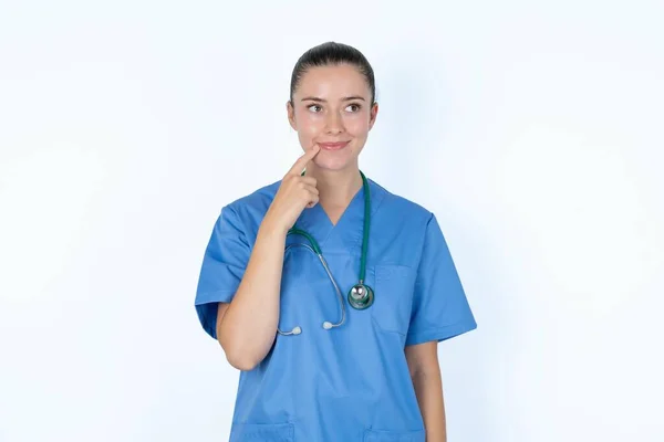 Lovely Caucasian Woman Doctor Uniform Stethoscope Keeps Finger Lips Looks — Stock Photo, Image