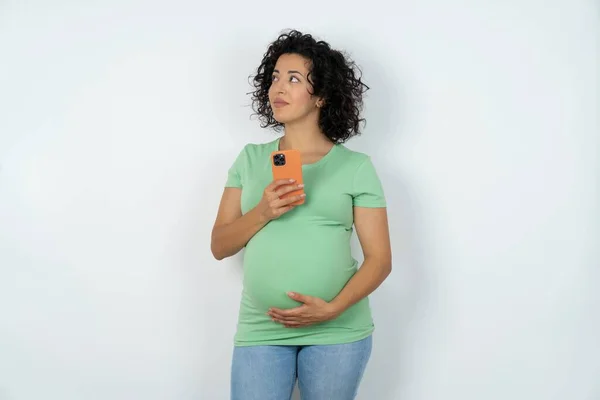 妊娠中の女性は携帯電話を高速インターネットで利用しソーシャルネットワークはオンライン通信を利用しています 現代技術の概念 — ストック写真