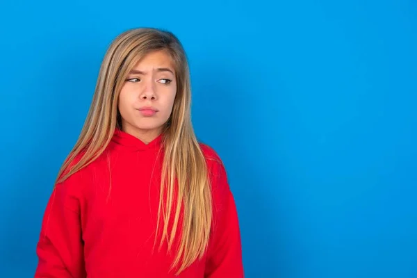 Beautiful Caucasian Teen Girl Wearing Red Sweater Blue Wall Looks — Stock Photo, Image