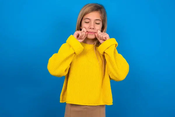 Pleased Beautiful Blonde Teen Girl Wearing Yellow Sweater Blue Wall — Stock Photo, Image