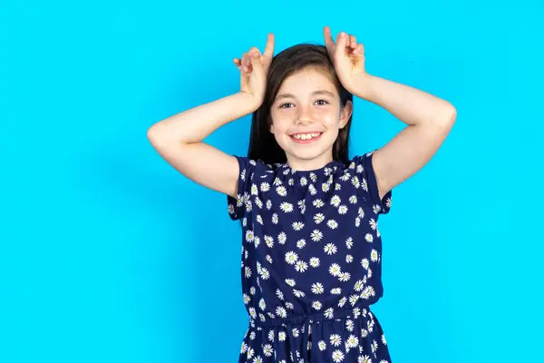 Funny Beautiful Kid Girl Wearing Floral Dress Blue Background Shows — Stock Photo, Image