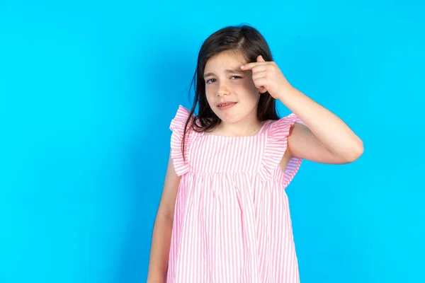 Beautiful Kid Girl Wearing Pink Dress Blue Background Pointing Unhappy — Stock Photo, Image