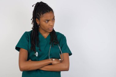 Closeup portrait displeased pissed off angry grumpy pessimistic doctor woman with bad attitude, arms crossed looking sideways. Negative human emotion facial expression feelings