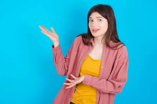 Young Caucasian Girl Wearing Pink Shirt Isolated Blue Background Pointing — Stock Photo, Image